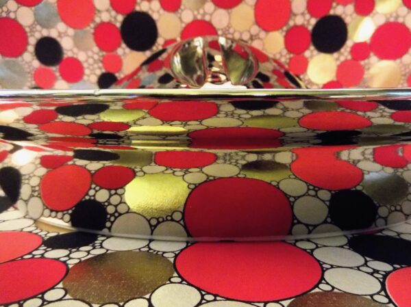 Closer View of Lid over Casserole with Reflection of Prints